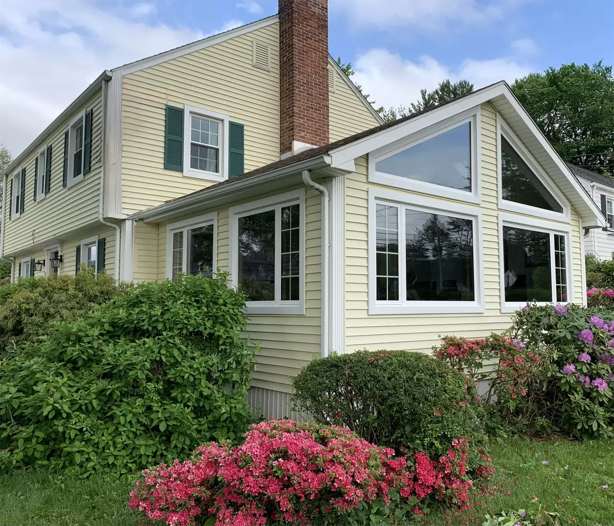 OKNA casement and double-Hung windows colonial home with sunroom trapezoid picture windows beautiful exterior trim Seven Sun CT
