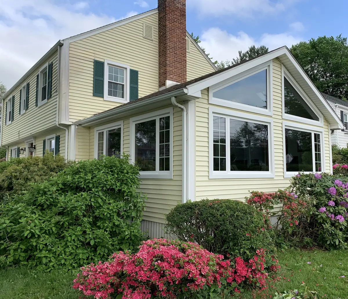 OKNA casement and double hung windows colonial home with sunroom trapezoid picture windows beautiful exterior trim Seven Sun CT