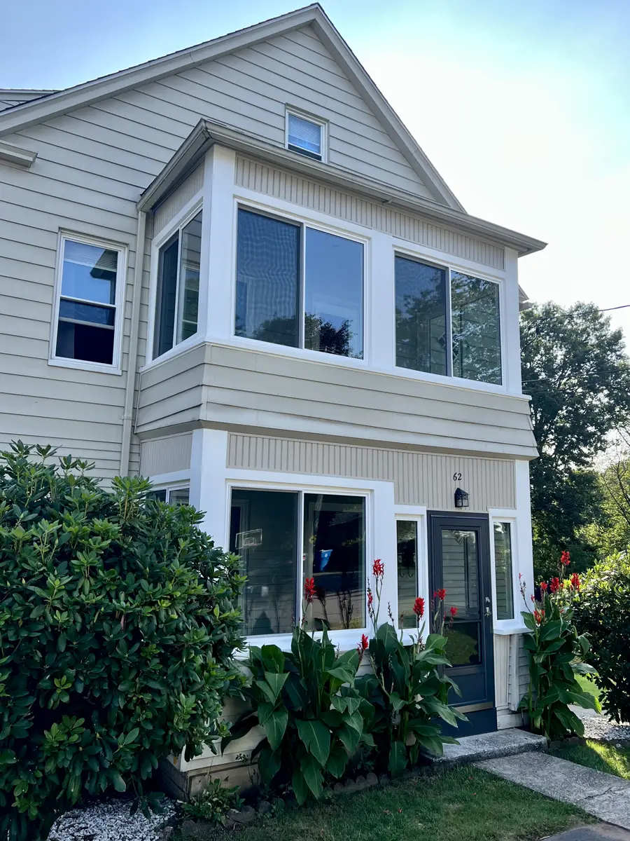 OKNA insul-tec 500 sliding windows installed in porch in colonial home white pvc aluminum exterior trim provia black spectrum storm door Seven Sun CT