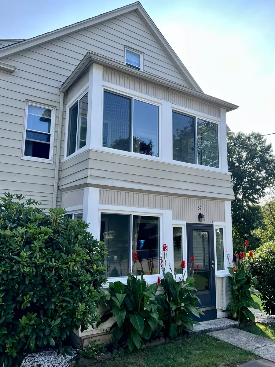 OKNA insul-tec 500 sliding windows installed in porch in colonial home white pvc aluminum exterior trim provia black spectrum storm door Seven Sun Connecticut