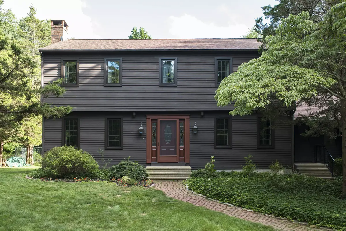 Okna casement windows_bronze exterior color colonial grids between glass raised ranch house front Seven Sun CT