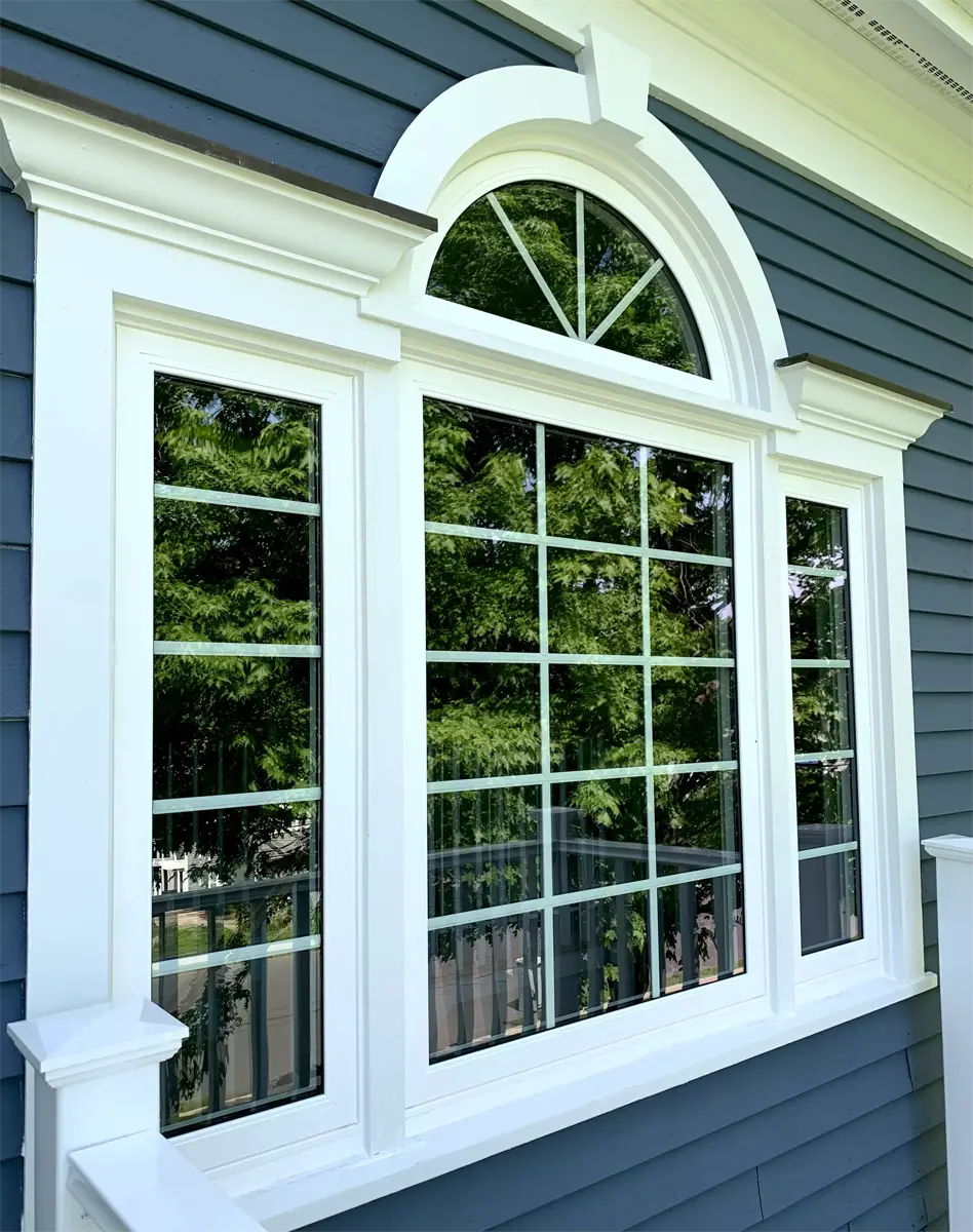 OKNA Circle Top window with sun burst grids over 3-lite casemen Seven Sun CT